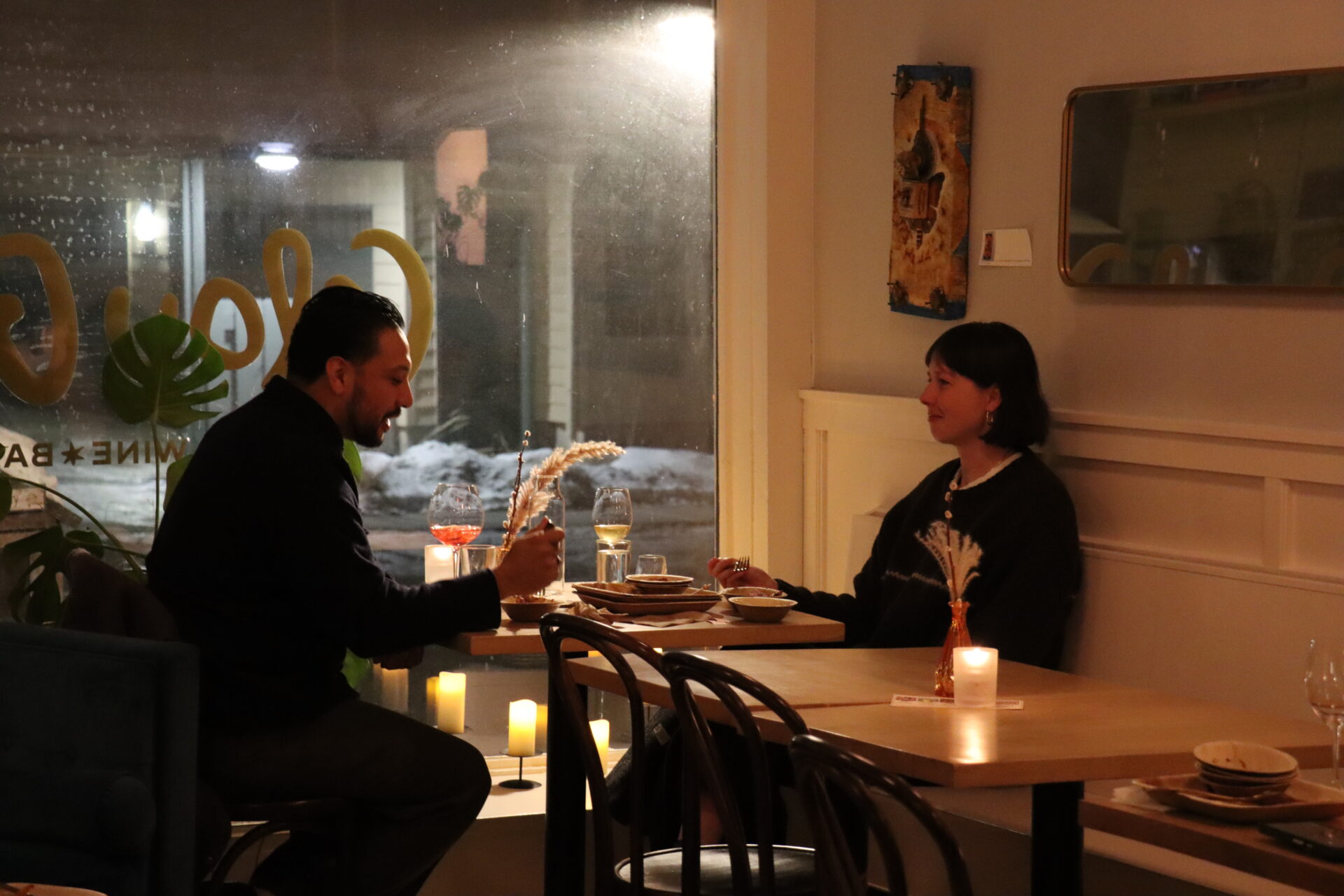 A couple enjoying a drink and a local food bite at Glou Glou wine bar