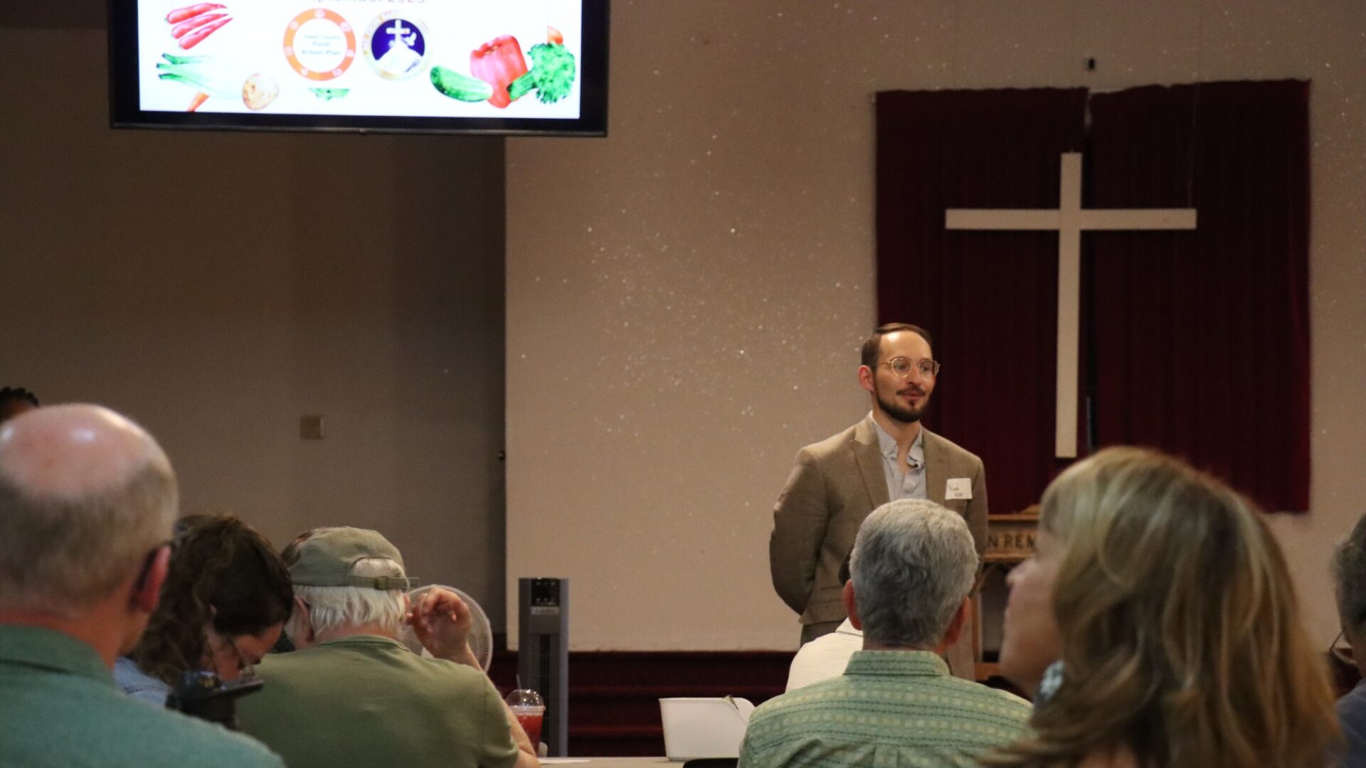 Speaker in front of a crowd at the front of a church
